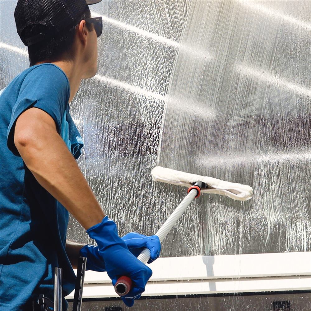 Exterior glass being washed with a squeegee
