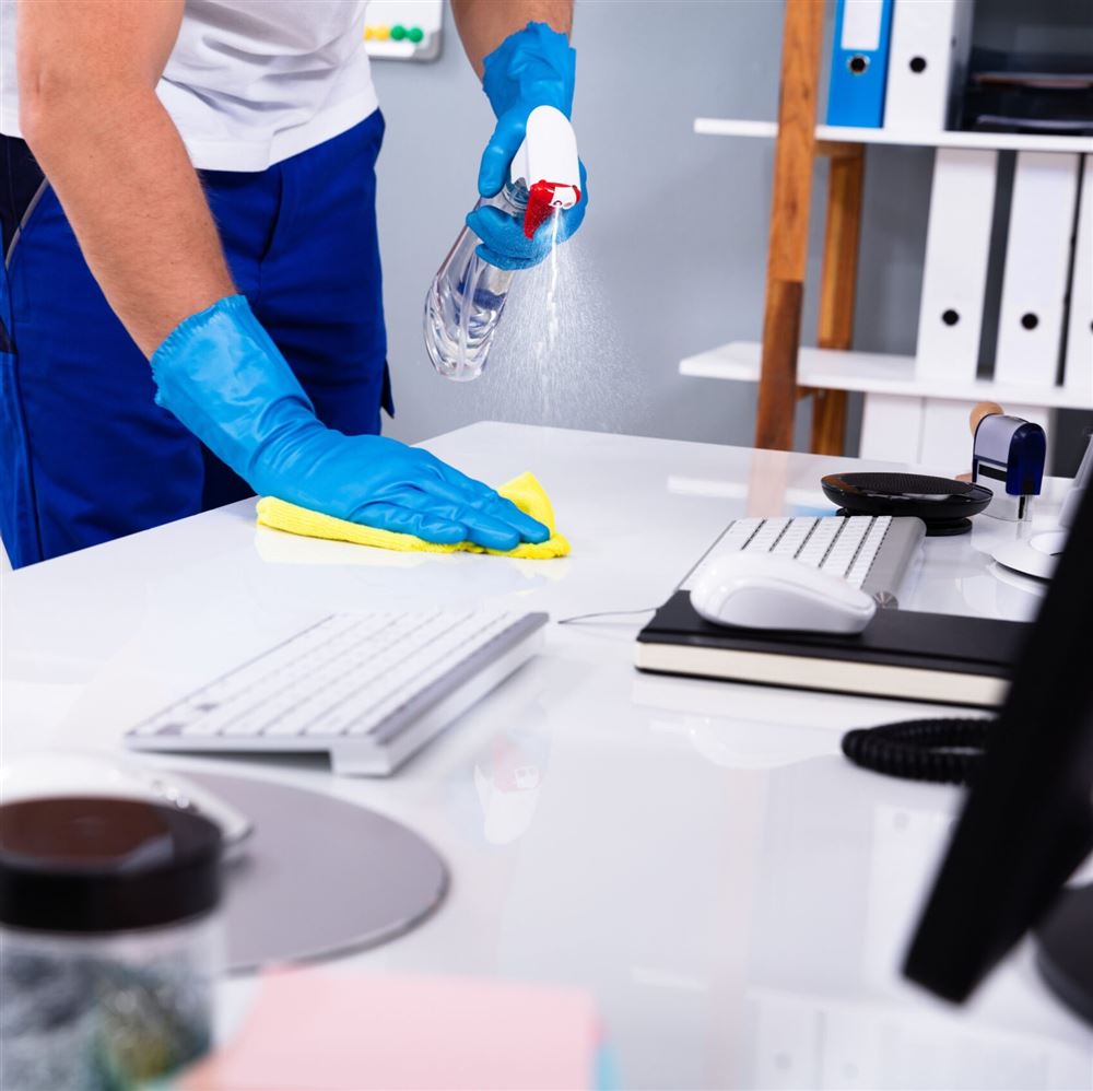 Office desk being cleaned